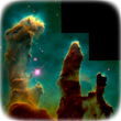 Eagle Nebula with its three pillars of different sizes that look like brown piles of gas clouds against a green background. Optical images taken by Hubble.